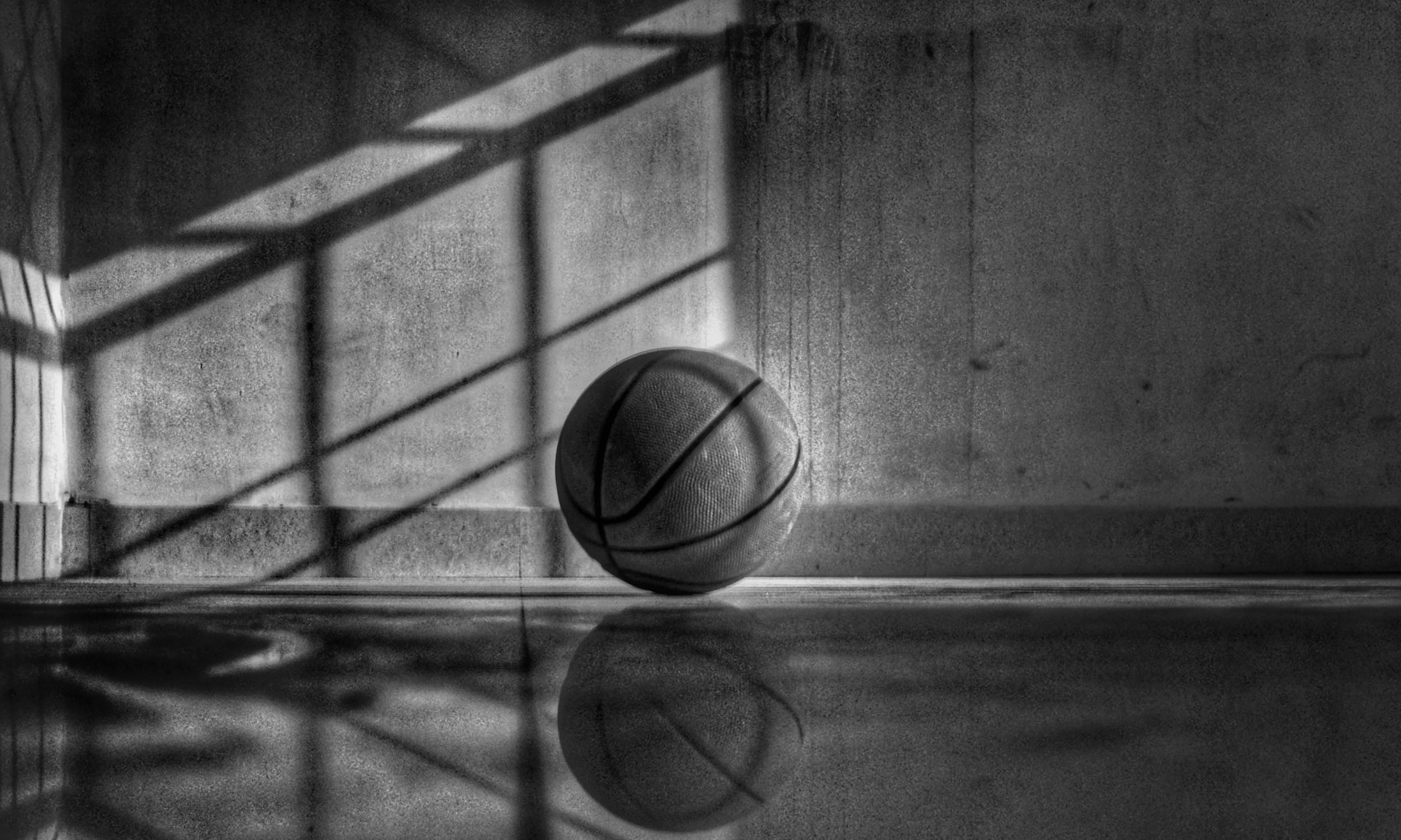 Dramatic picture of basketball laying in a basketball court